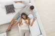 Smiling woman laying on man?s lap on sofa