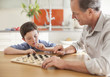 Grandfather and grandson playing checkers