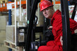 Photo: forklift driver worker in red uniform and safety helmet forklift driver worker in red uniform and safety helmet