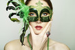 The beautiful young woman in a green mysterious venetian mask The beautiful young woman in a green mysterious venetian mask