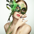 The beautiful young woman in a green mysterious venetian mask