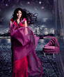 stunning woman in eveningdress on a terrace under a starry sky /