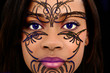 Close Up Beautiful Black Woman with Plastic Henna Art on Face