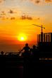 People see sunset and construction building People see sunset and construction building
