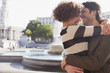 Happy couple hugging in city