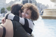 Portrait of smiling couple hugging in front of fountain