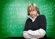 Photo: angry teacher with blackboard on the background angry teacher with blackboard on the background