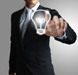 ฺBusiness man pressing light bulb