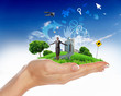 Human hand holding a green landscape