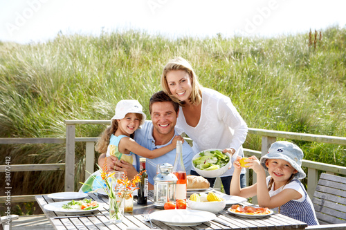Photo: Family on vacation eating outdoors Family on vacation eating outdoors