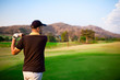 Golfer teeing off