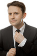 Photo: businessman straightens his tie businessman straightens his tie