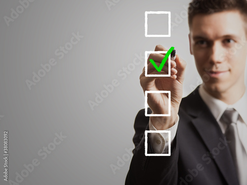 Photo: businessman - tick off checklist businessman - tick off checklist