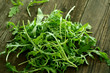 fresh rucola on old wooden boards fresh rucola on old wooden boards