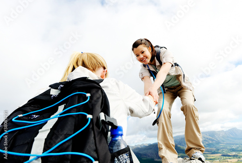 Photo: Healthy young women climbing outdoors Healthy young women climbing outdoors