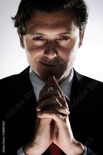Photo: Cunning looking man thinking Cunning looking man thinking
