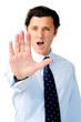Unhappy man stretches his arm in a stop gesture