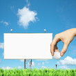 Advertising of golf events : blank billboard and hand holding a