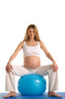pregnant woman practicing yoga with blue ball pregnant woman practicing yoga with blue ball