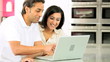 Young Ethnic Couple Online with Wireless Laptop