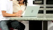 Asian Couple with Laptop Having Online Success