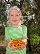 The child with sea-buckthorn berries in hands The child with sea-buckthorn berries in hands