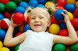 The little girl lies on color balls The little girl lies on color balls
