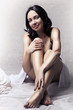 Sexy woman on white bed with long beautiful leg.