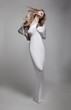 Luxurious mystical young woman in white clothes posing