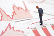 Financial crisis. Figure of businessman on financial charts