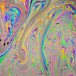 Photo: Macro closeup of colorful soap bubble solution Macro closeup of colorful soap bubble solution