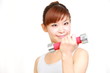 young japanese woman doing dumbbell exercises