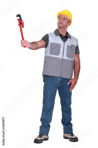 Photo: Man holding a pipe wrench Man holding a pipe wrench