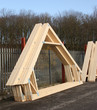 A Stack of Timber Roof Trusses in a Stock Yard.
