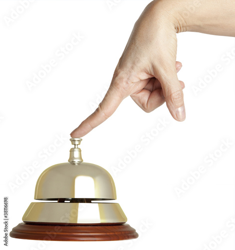 Photo: Hand of a woman using a hotel bell isolated Hand of a woman using a hotel bell isolated