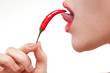 Фото: Young woman with chili pepper isolated on white Young woman with chili pepper isolated on white
