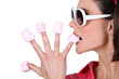 Photo: Woman biting in marshmallow Woman biting in marshmallow