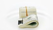 Bundle of many 100 dollar notes rotating on white background Bundle of many 100 dollar notes rotating on white background