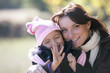 Mother and daughter outside on a sunny winter's day