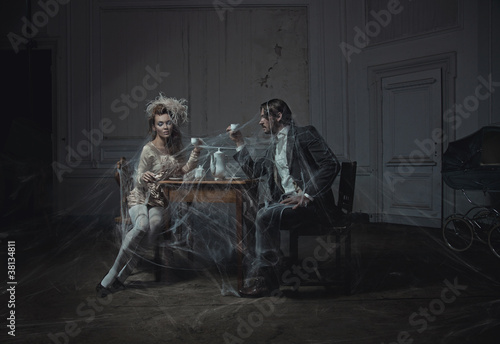 Photo: Young couple drinking coffee in an old castle Young couple drinking coffee in an old castle