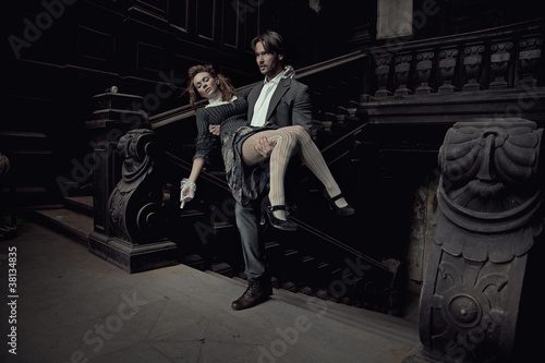Photo: Elegant man carrying a beautiful brunette Elegant man carrying a beautiful brunette
