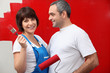 Couple painting a room bright red