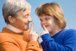 A girl with Down syndrome and her grandmother whispering