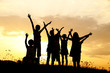 Silhouette, group of happy children playing on meadow,