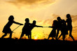 Silhouette, group of happy children playing , sunset, summertime