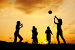Silhouette, group of happy children playing on meadow
