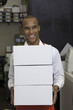 Cheerful worker holding containers