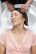Asian woman having hair wash at beauty salon