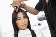 Young woman having haircut at beauty salon