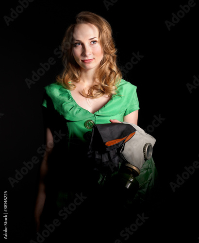 Photo: Woman holding flowers and gas mask . Woman holding flowers and gas mask .